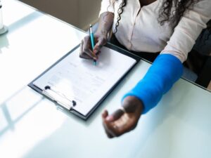 woman signing insurance papers