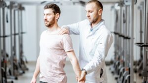 senior physiotherapist doing treatment to a man with spine problems