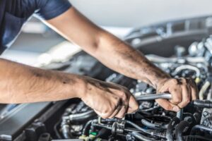 Auto Mechanic Working on Car Engine