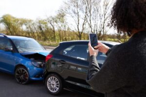 woman taking photo of a car accident
