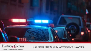 Close-up of a police car with red and blue lights flashing at night during a hit and run incident in Raleigh
