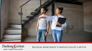 Property manager showing a tenant an unsafe area inside an apartment building, representing apartment complex injury cases in Raleigh.