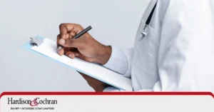 A doctor completing a medical source statement form to support a patient's Social Security disability claim.