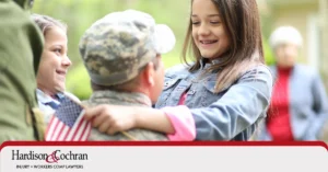 veteran soldier holding daughters in arms