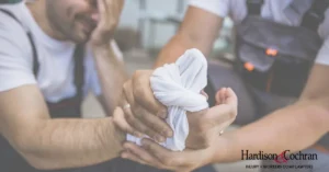 Greensboro factory worker with a burn injury on the job receiving first aid